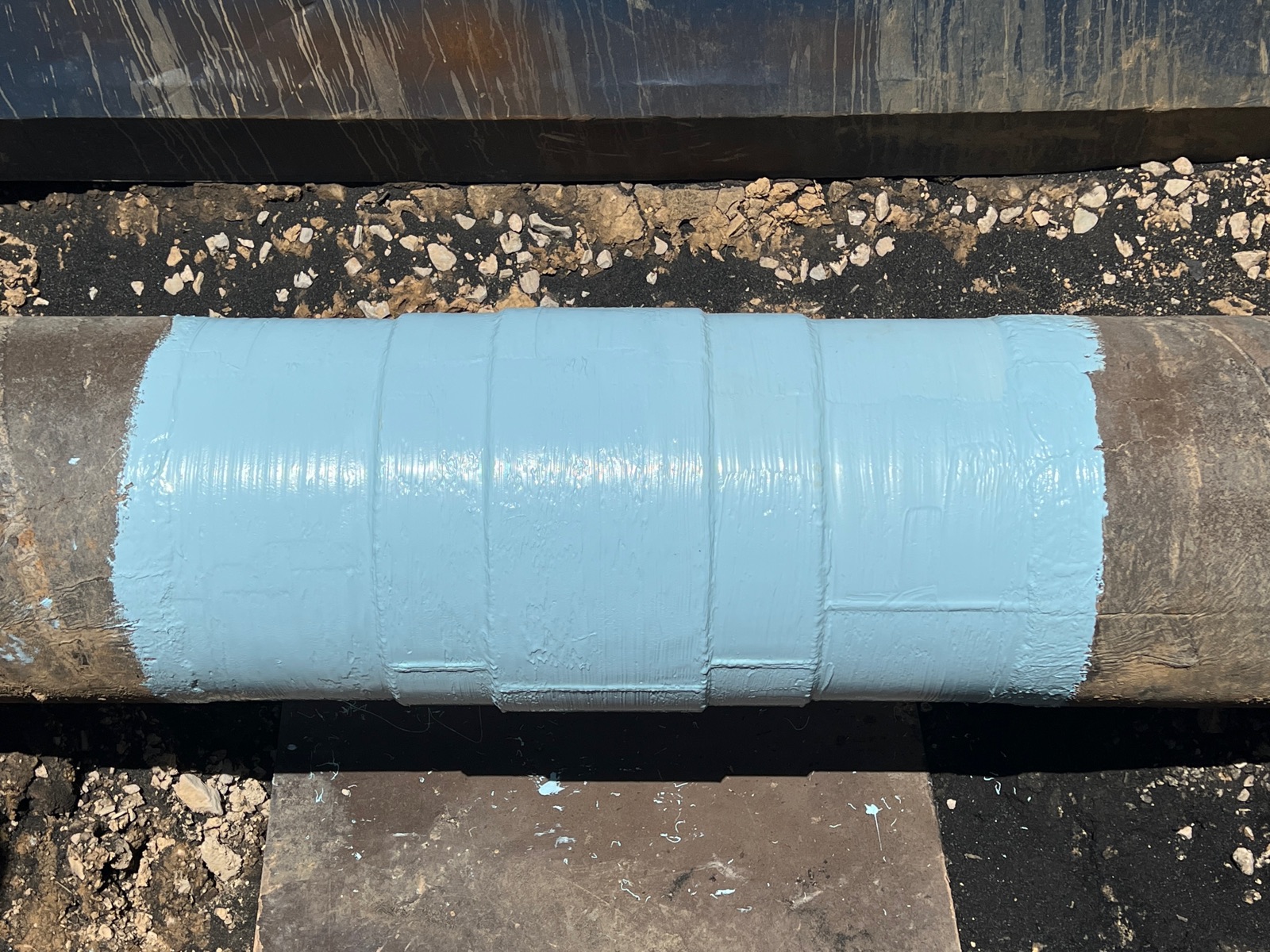 In-service weld and coating inspection on an exposed pipe joint